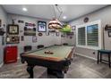 Entertaining game room featuring a pool table, TV, and sports memorabilia for fun gatherings and relaxation at 11148 E Tumbleweed Ave, Mesa, AZ 85212