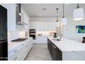 Stylish kitchen with stainless steel appliances, white cabinetry, and a large center island with bar seating at 14429 N 75Th Dr, Peoria, AZ 85381