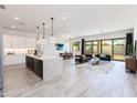 Open-concept living space with modern kitchen, dining, and living areas at 14429 N 75Th Dr, Peoria, AZ 85381