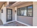 Inviting front porch featuring a stylish door, tile flooring, and a large window at 1550 N Stapley Dr # 21, Mesa, AZ 85203