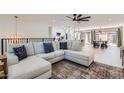 Open-concept living room with a large sectional sofa and views into the kitchen and dining area at 1550 N Stapley Dr # 21, Mesa, AZ 85203