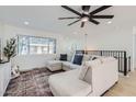 Cozy living room with a large sectional sofa and a modern ceiling fan at 1550 N Stapley Dr # 21, Mesa, AZ 85203