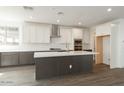 Bright kitchen featuring an island, white cabinets, and stainless steel appliances at 1565 E Tiffany Way, Gilbert, AZ 85298