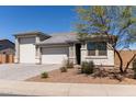 Charming single-story home featuring a three-car garage and desert landscaping at 1644 E Joelle Dr, Casa Grande, AZ 85122