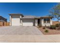 Charming single-story home featuring a three-car garage and desert landscaping at 1644 E Joelle Dr, Casa Grande, AZ 85122