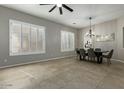 Bright dining room featuring plantation shutters, modern lighting, and open layout at 17370 W Pima St, Goodyear, AZ 85338