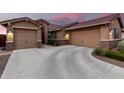Beautiful home featuring a spacious driveway, three-car garage, and manicured bushes at 18368 W Long Lake Rd, Goodyear, AZ 85338