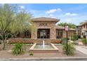 Elegant clubhouse entrance with stone accents, fountain and manicured landscaping, plus visible fire lane at 20100 N 78Th Pl # 2203, Scottsdale, AZ 85255