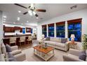 Open-concept living room showcases recessed lighting, kitchen island with barstool seating, and a cozy seating arrangement at 21525 E Camacho Rd, Queen Creek, AZ 85142