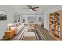 Bright living room with neutral tones, ceiling fan, and stylish striped rug at 217 E Gwen St, Phoenix, AZ 85042