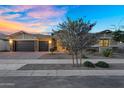 Charming home with a well-maintained front yard, desert landscaping, a brick driveway and a three-car garage at 22884 E Via De Olivos --, Queen Creek, AZ 85142