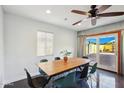 Bright dining room boasts a wooden table, modern chairs, and sliding glass doors with backyard view at 2511 E Pinchot Ave, Phoenix, AZ 85016