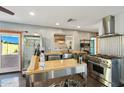 Contemporary kitchen features stainless steel appliances, an island, and a large window over looking the backyard at 2511 E Pinchot Ave, Phoenix, AZ 85016