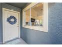 Welcome to unit 212 showcasing a lovely wreath, front door, and window view of the kitchen at 255 S Kyrene Rd # 212, Chandler, AZ 85226
