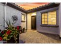 Enclosed courtyard with patterned brick, a bench, and a decorative metal sunburst wall hanging at 26999 W Ponderosa Ln, Buckeye, AZ 85396