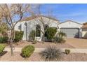 Charming single-Gathering home featuring manicured landscaping, a tile roof, and an attached two-car garage at 2896 E Maplewood St, Gilbert, AZ 85297