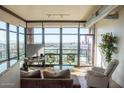 Inviting living room with floor-to-ceiling windows and access to balcony with expansive city views at 310 S 4Th St # 901, Phoenix, AZ 85004