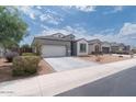 Street view showing single-story home with well-maintained front yard and two-car garage at 31045 W Mulberry Dr, Buckeye, AZ 85396
