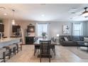 Open floor plan features a dining area adjacent to the living room and kitchen at 31045 W Mulberry Dr, Buckeye, AZ 85396