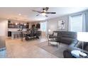 Open-concept living space features modern furnishings, tile flooring, and abundant natural light at 31045 W Mulberry Dr, Buckeye, AZ 85396