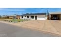 Inviting home featuring a well-maintained yard, spacious driveway, and a modern, freshly painted exterior at 3330 E Palm Ln, Phoenix, AZ 85008