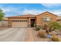 Charming single-story home with desert landscaping, two-car garage and security system at 37161 W Giallo Ln, Maricopa, AZ 85138