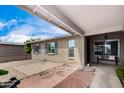 Covered porch area showcasing neutral brick facade with a walkway that adds character at 4138 W Barbara Ave, Phoenix, AZ 85051