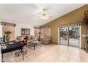 Open-concept living room featuring tile flooring, a ceiling fan and neutral decor at 42491 W Chisholm Dr, Maricopa, AZ 85138
