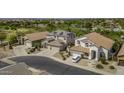 An aerial view of a neighborhood showcasing well-maintained homes with tile roofs and lush landscaping at 43650 W Snow Dr, Maricopa, AZ 85138