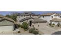 Charming two-story home with a three car garage, complemented by low maintenance landscaping at 43650 W Snow Dr, Maricopa, AZ 85138