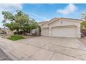 Single-story home featuring a two-car garage, landscaped front yard, and a classic tile roof at 4522 S Wildflower Pl, Chandler, AZ 85248