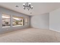 Inviting living room with neutral carpet, large windows overlooking the backyard, and a serene atmosphere at 4522 S Wildflower Pl, Chandler, AZ 85248