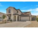 Attractive stucco home with a red tile roof, arched entryway, and spacious driveway at 5222 W El Cortez Trl, Phoenix, AZ 85083