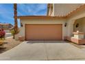 A two car garage with brown colored doors and desert landscaping at 6626 W Laurel Ave, Glendale, AZ 85304