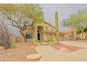 Charming two-story stucco home, desert landscaping, covered entry, and three-car garage at 6778 W Lariat Ln, Peoria, AZ 85383