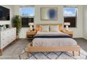 Bright bedroom featuring neutral walls, modern decor, large windows, and natural light at 7215 N 123Rd Dr, Glendale, AZ 85307