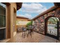 Private brick patio featuring wrought iron furniture and gate at 7216 E Aurora --, Scottsdale, AZ 85266