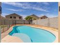 Backyard pool surrounded by a concrete deck and block wall, providing a relaxing and private outdoor space at 7622 S 69Th Dr, Laveen, AZ 85339
