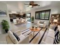 Bright, open-concept living area with tile floors, neutral furniture, and an eat-in kitchen at 7924 S 70Th Ln, Laveen, AZ 85339