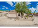 Charming single-story home with a well-maintained yard and two car garage at 10064 E Kilarea Ave, Mesa, AZ 85209