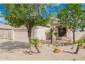 Charming single-story home with a well-maintained desert yard and a two car garage at 10064 E Kilarea Ave, Mesa, AZ 85209