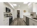 Updated kitchen features white cabinets, modern stainless steel appliances, and neutral decor at 10927 W Peoria Ave, Sun City, AZ 85351