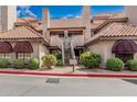 Charming two-story condo with desert landscaping, red tile roof, and neutral-colored stucco at 1211 N Miller Rd # 213, Scottsdale, AZ 85257