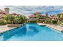 Inviting community pool surrounded by lush landscaping and comfortable seating at 1211 N Miller Rd # 213, Scottsdale, AZ 85257