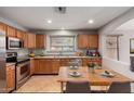 Cozy kitchen featuring wood cabinets, stainless steel appliances, and eat-in dining area at 12427 W El Nido Ln, Litchfield Park, AZ 85340