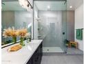 Modern bathroom with dual sinks, a walk-in shower, and neutral gray finishes at 14407 N 75Th Dr, Peoria, AZ 85381