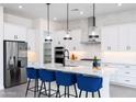 Well-equipped kitchen featuring an island with seating, stainless appliances, and pendant lights at 14407 N 75Th Dr, Peoria, AZ 85381