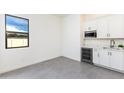Additional kitchenette boasts built-in wet bar area, ample storage, and tons of natural light at 14407 N 75Th Dr, Peoria, AZ 85381