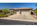 Spacious three-car garage accented with stone pillars and a large driveway at 1557 W Laurel Greens Ct, Anthem, AZ 85086
