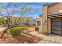 Home exterior showing desert landscaping and a stone accent wall near the entrance with a tiled walkway at 16010 E Summit View Dr, Fountain Hills, AZ 85268